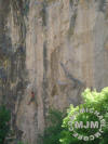 Climber in mid-crux on Satch